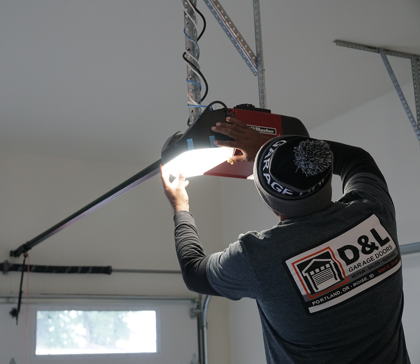 Technician repairing garage door opener